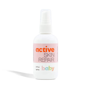 Bottle of active skin repair baby spray on a white background