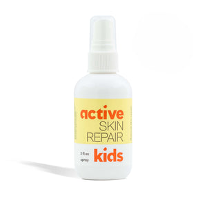 Bottle of 'active skin repair kids' spray on a white background