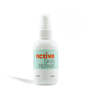 Bottle of active skin repair spray on a white background