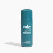 Blue bottle of 'active skin repair' sunscreen on a white background